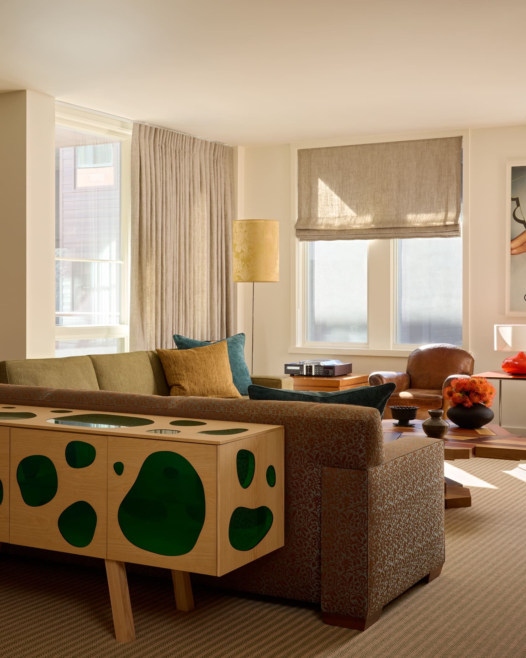 Art collector's living room featuring custom JMF sofas, marble fireplace and mountain views in Aspen penthouse