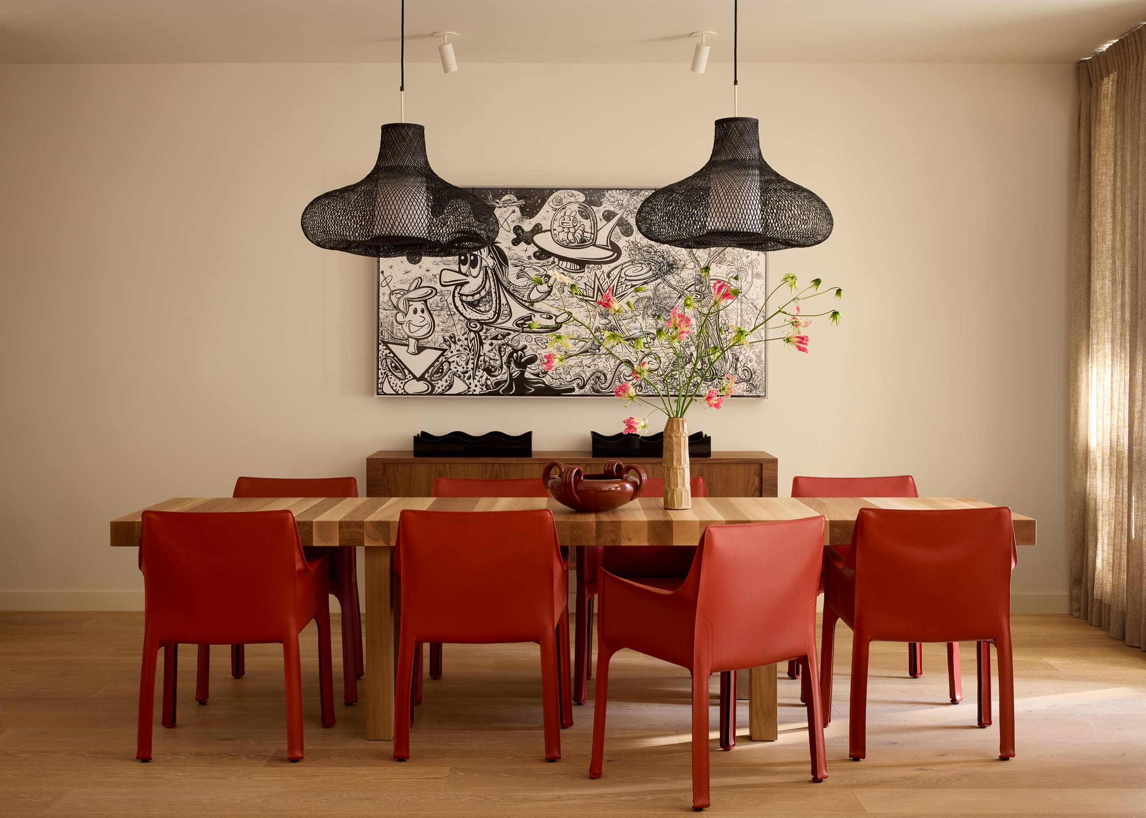 Open plan dining area with custom Miguel Saco dining table and Cab armchairs by Cassina, Aspen penthouse interior
