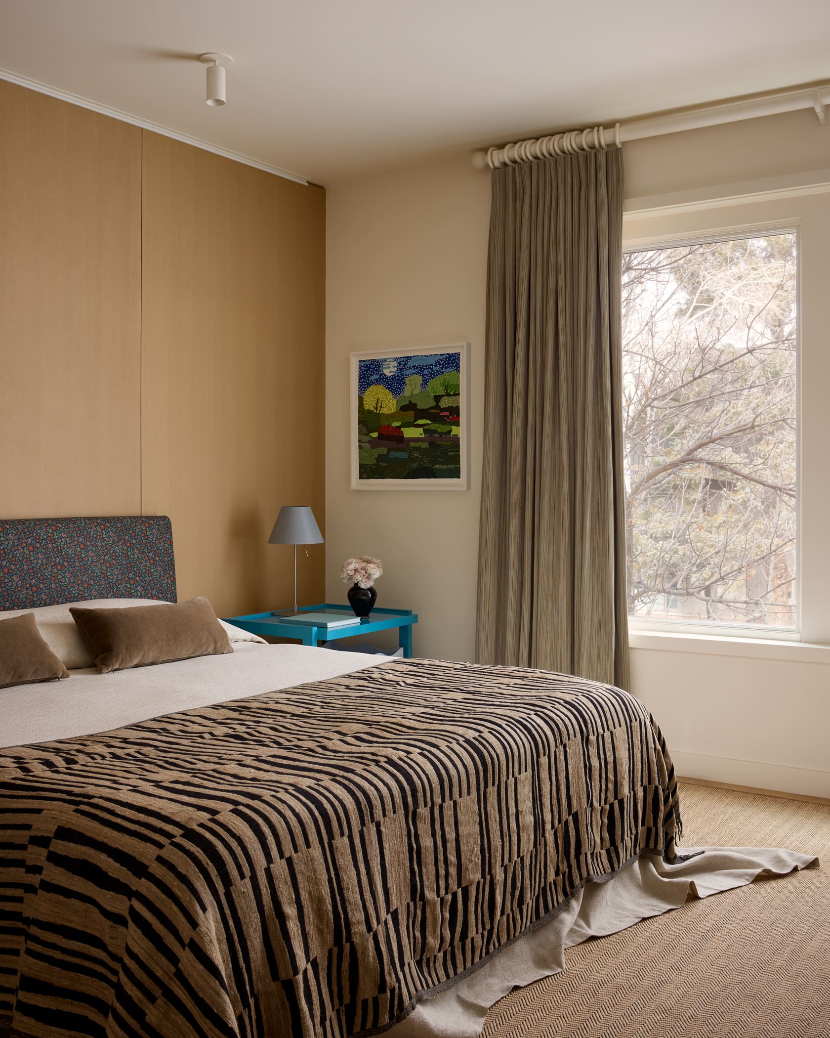 Primary bedroom with light neutral palette and custom window treatments in Aspen luxury penthouse